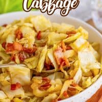 Pinterest image of Bacon Fried Cabbage with spoon in serving bowl.