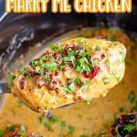 A piece of Marry Me Chicken on a serving utensil over a Crock Pot.