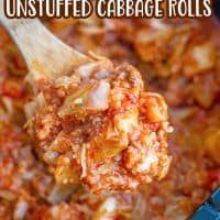 a wooden spoon holding up a serving of unstuffed cabbage rolls over an oval slow cooker.