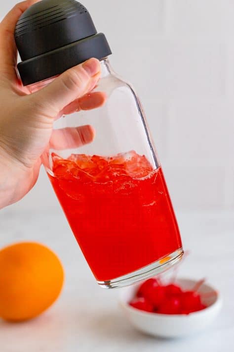 Cocktail shaker shaking the drink together.