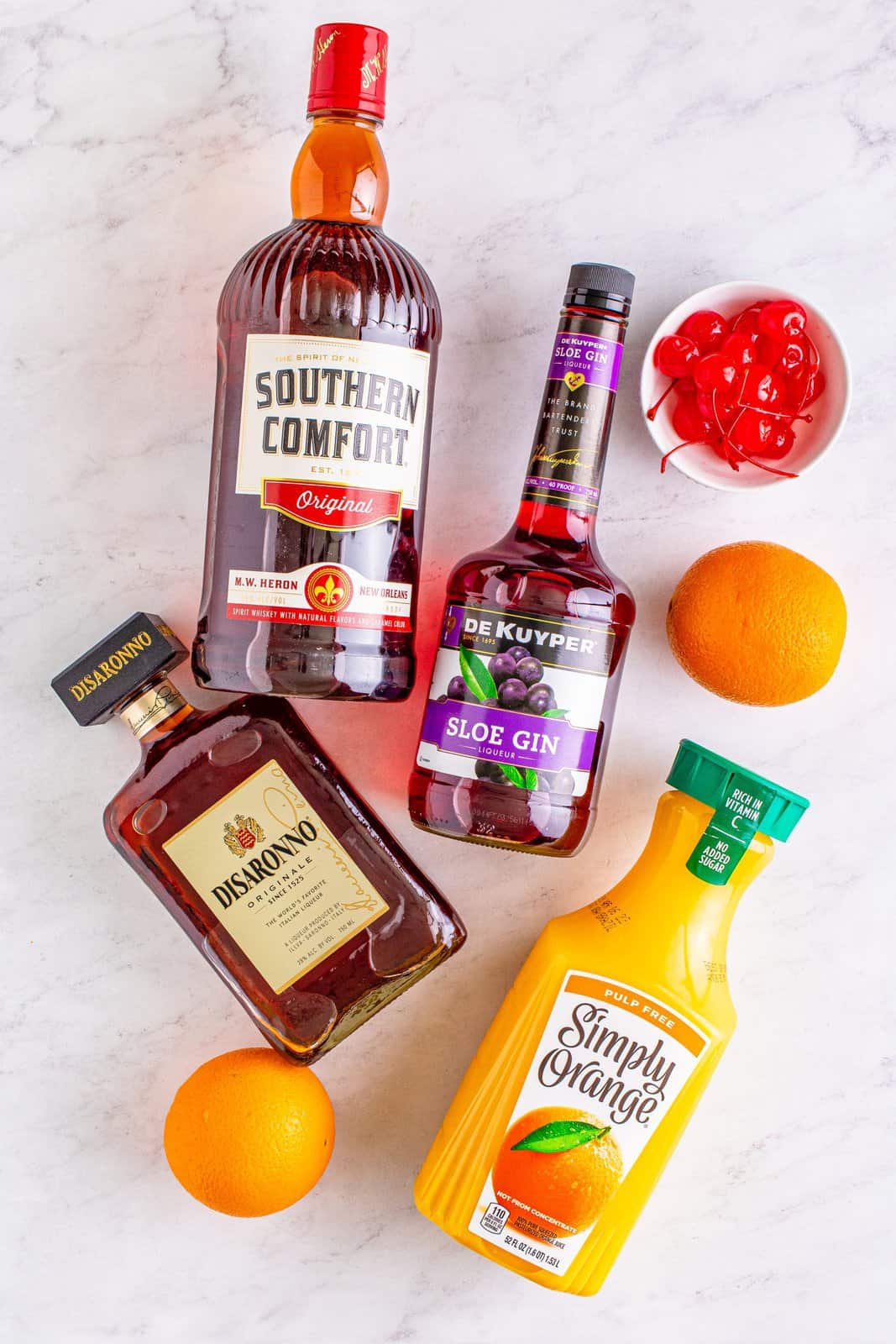 Ingredients needed: amaretto, sloe gin, southern comfort, orange juice, maraschino cherries and sliced oranges.