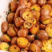 Closely looking down on a serving dish of Cowboy Butter Potatoes.