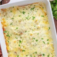 Looking down closely on a baking dish of White Chicken Enchilada Casserole.